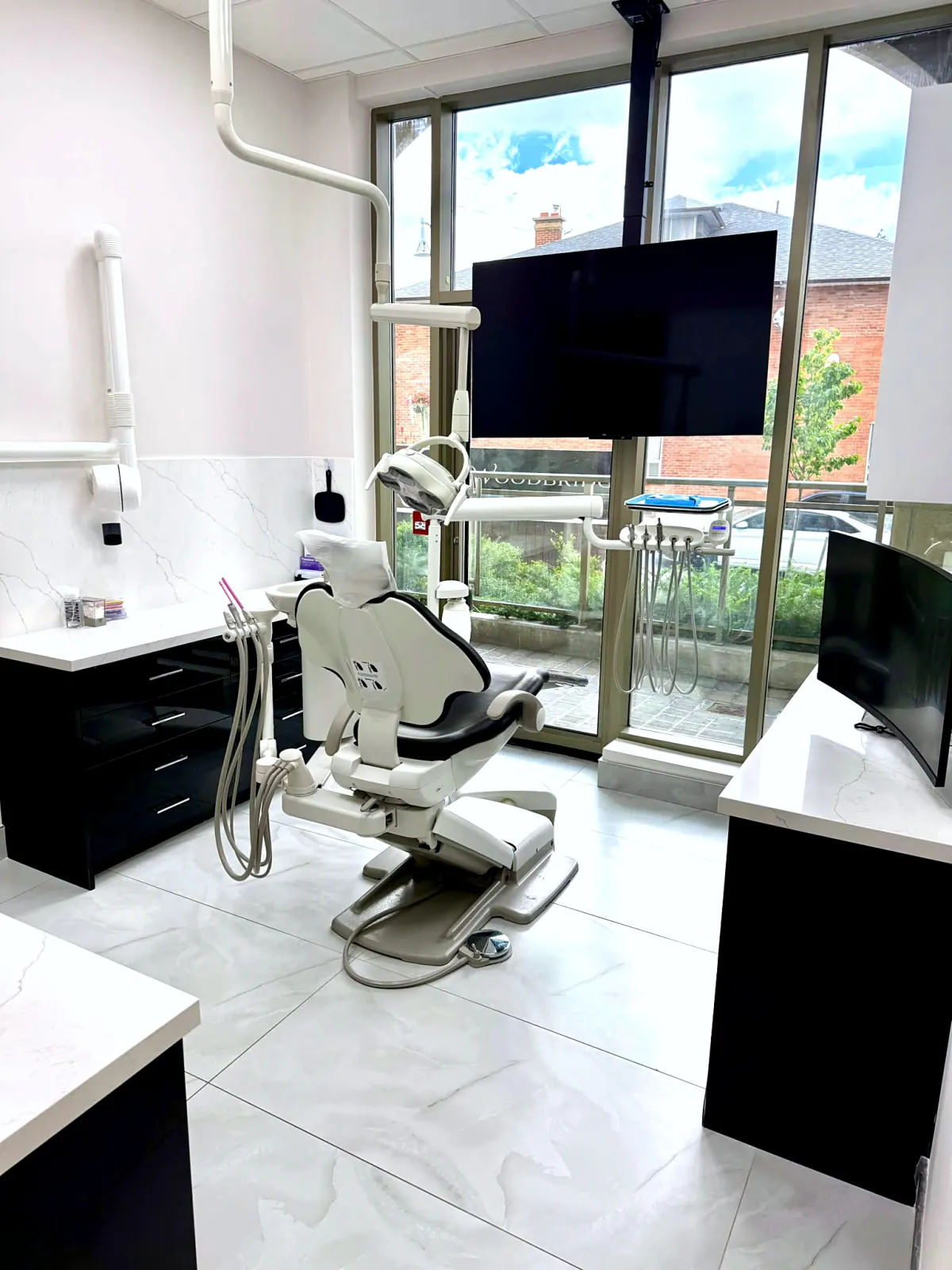Modern dental treatment room with floor-to-ceiling windows in Woodbridge