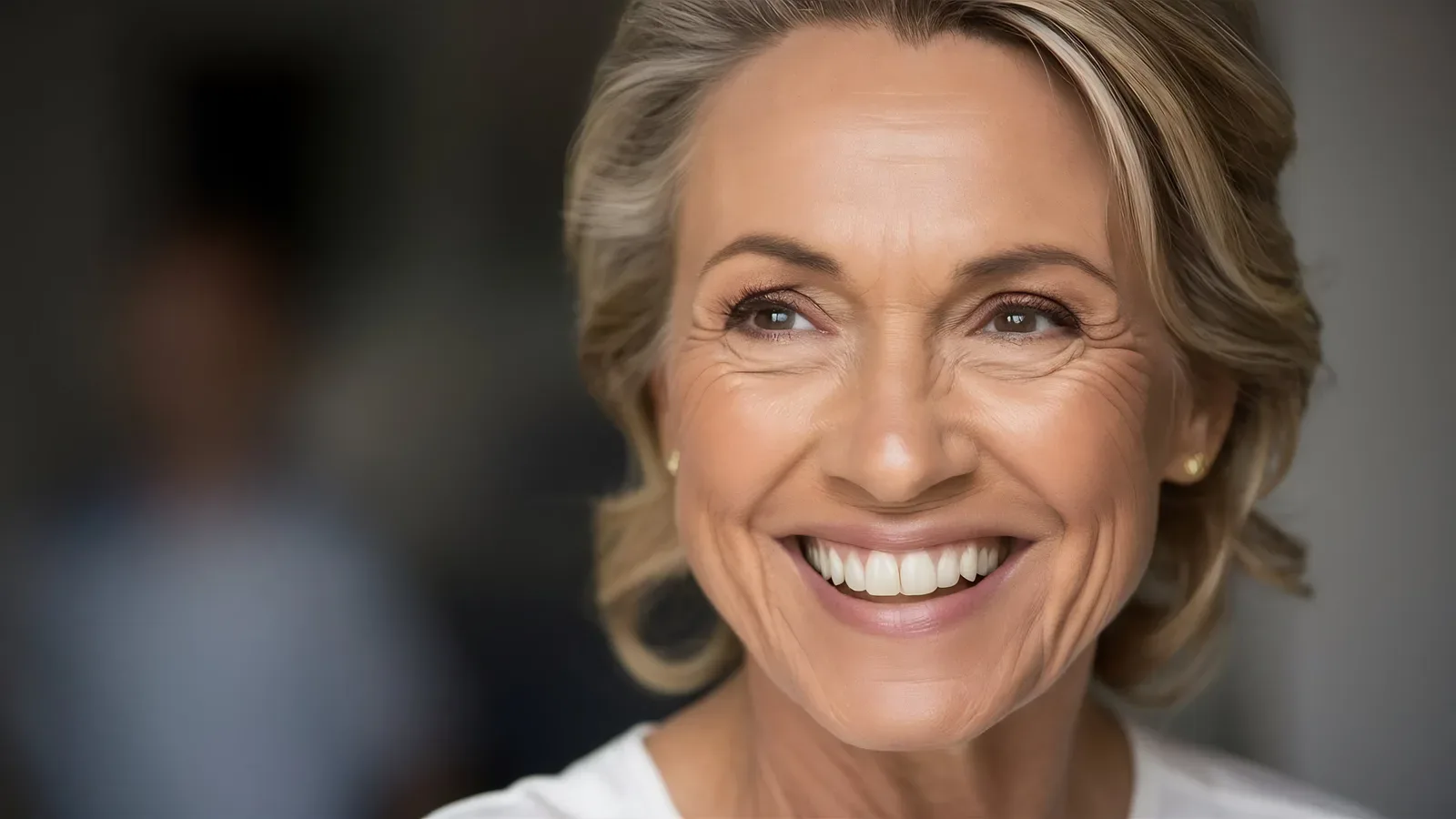 Smiling older woman with shoulder-length blonde hair